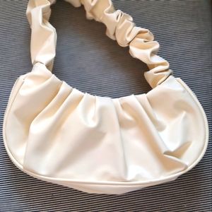 Cream colored ruched handbag